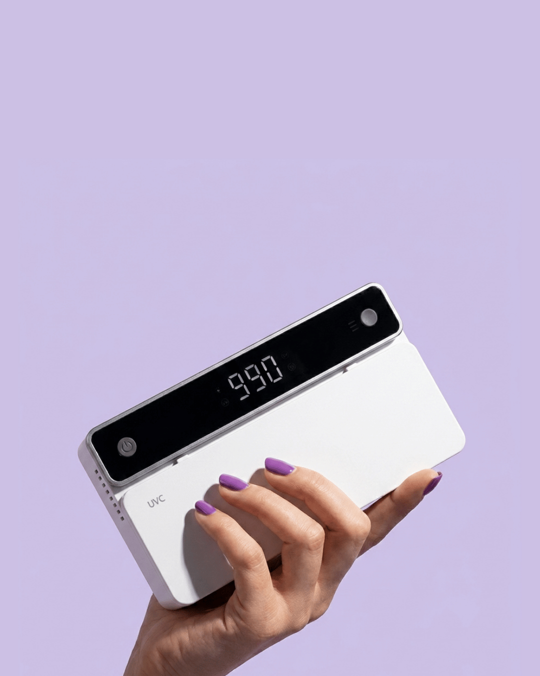 Hand holding a digital device with a purple background