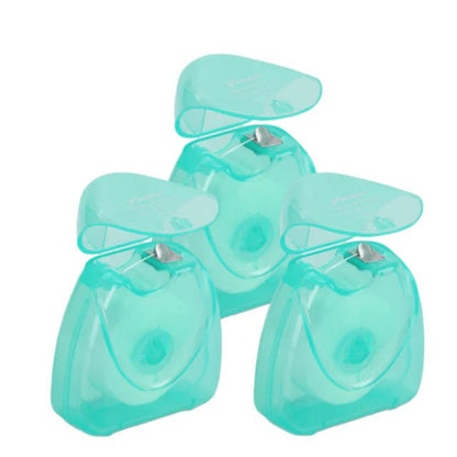 Set of four turquoise dental floss on a white background