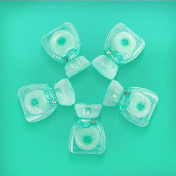 Clear plastic components on a teal background