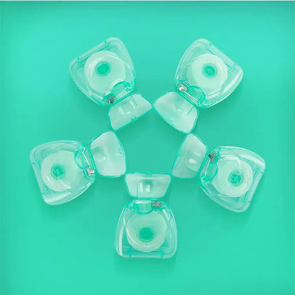 Clear plastic components on a teal background